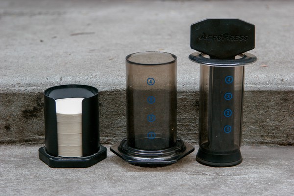 AeroPress® The components of an AeroPress® standing on a concrete step